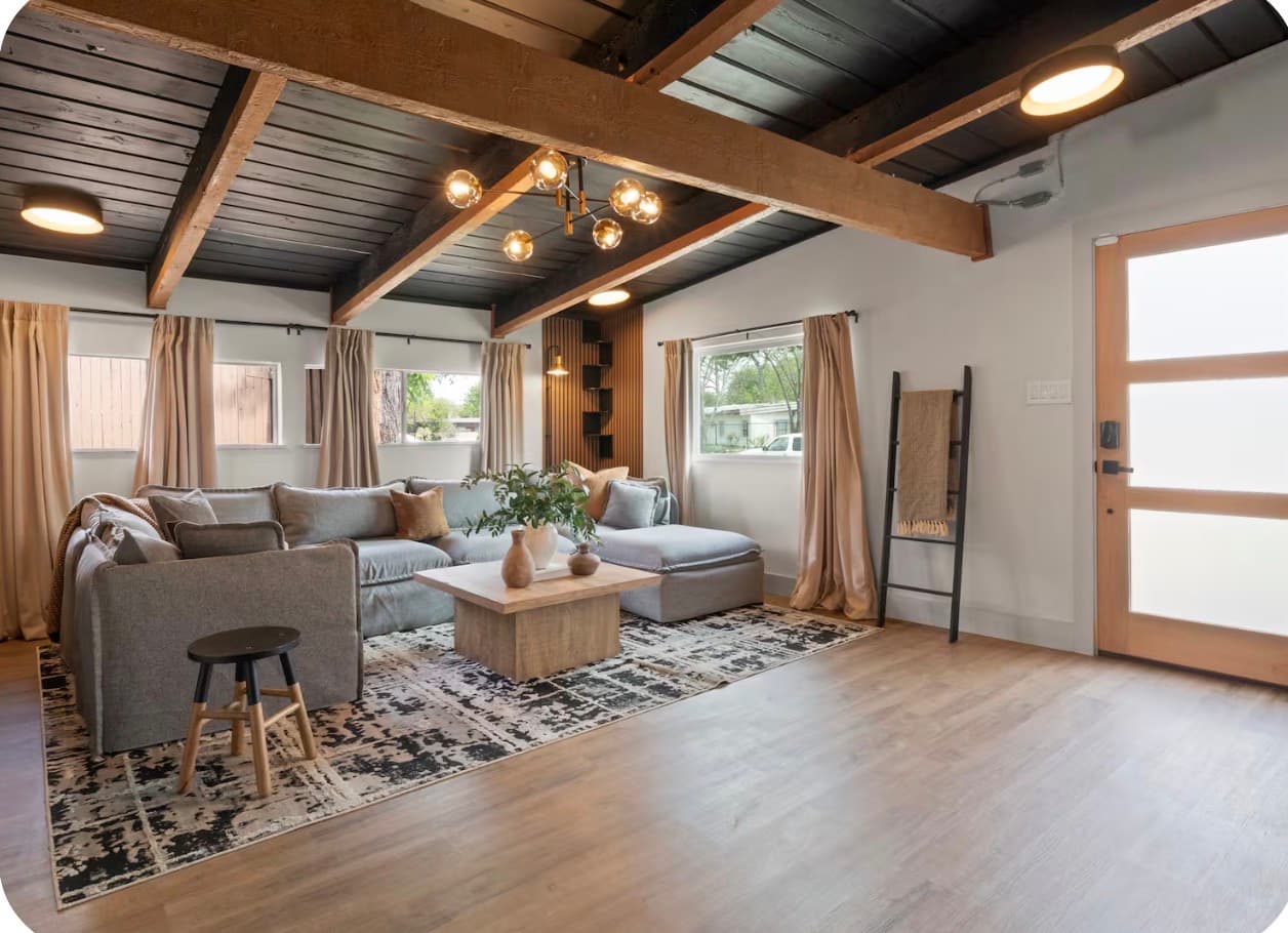 Living room and front entry with exposed wood details at the Dallas Creative Connect location.