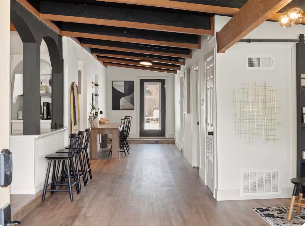 Long open hallway with a mud-area bench and doorway at the Dallas Creative Connect location.